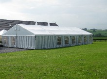 You have here a striped aluminium marquee situated in the countryside